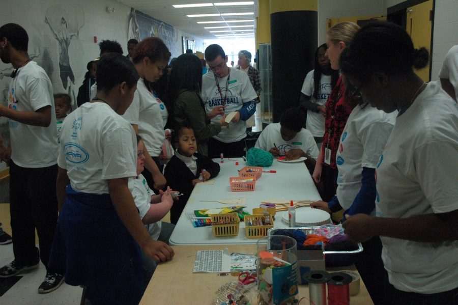 Buddies and participants enjoy a craft at last years Special Olympics event. On March 7th, Central will once again host basketball and other games for area special needs students.