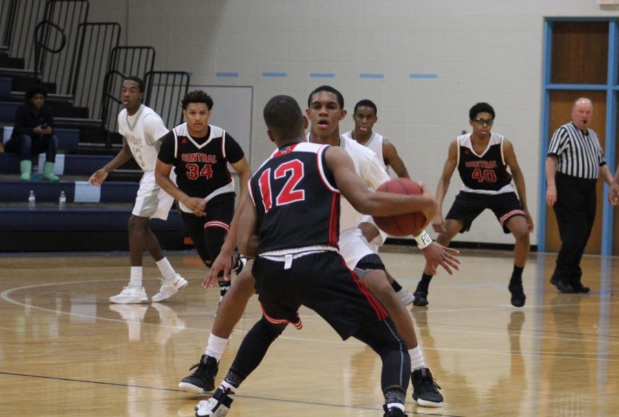 Senior Shaun Williams (center) is just one of many talented players returning to the varsity basketball team this year, leading to high expectations for success.