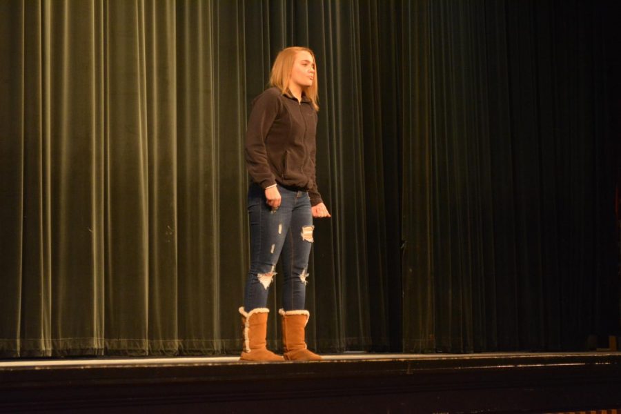 Sophomore Samantha Beeman recites a poem, "I find no peace" by Thomas Wyatt during the Poetry Out Loud competition in the auditorium on January 24th.